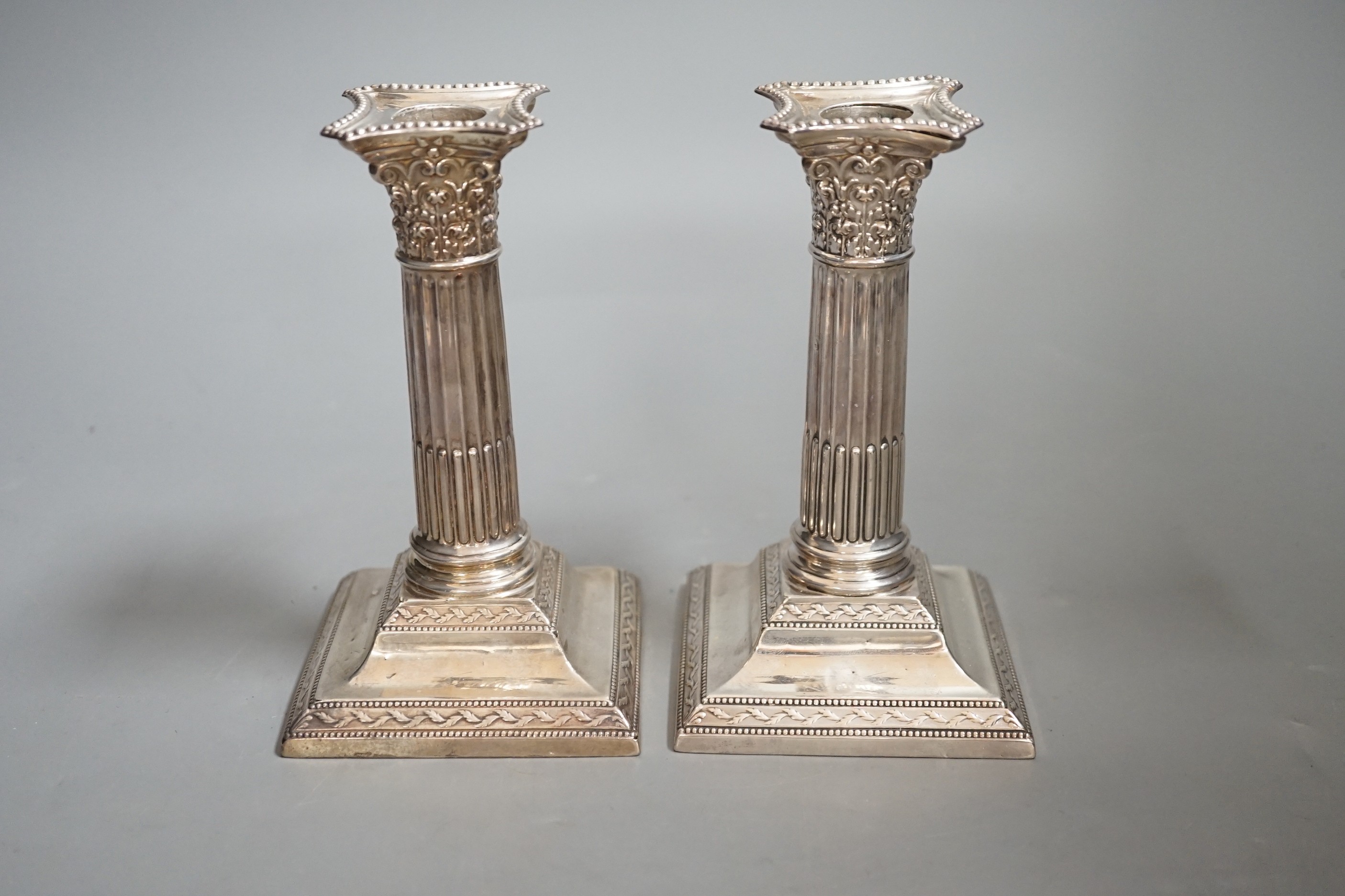 A pair of late Victorian silver Corinthian column dwarf candlesticks, W & G Sissons, London, 1897, 14.5cm, weighted.